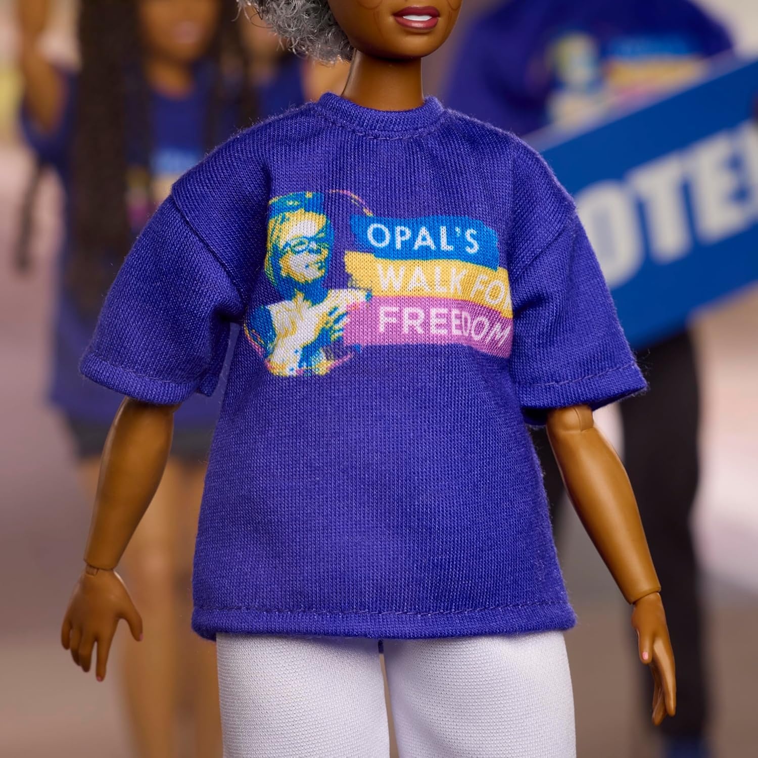 imageBarbie Inspiring Women Doll Opal Lee Collectible in Blue Opals Walk for Freedom TShirt White Pants and Glasses Doll Stand and Displayable Packaging