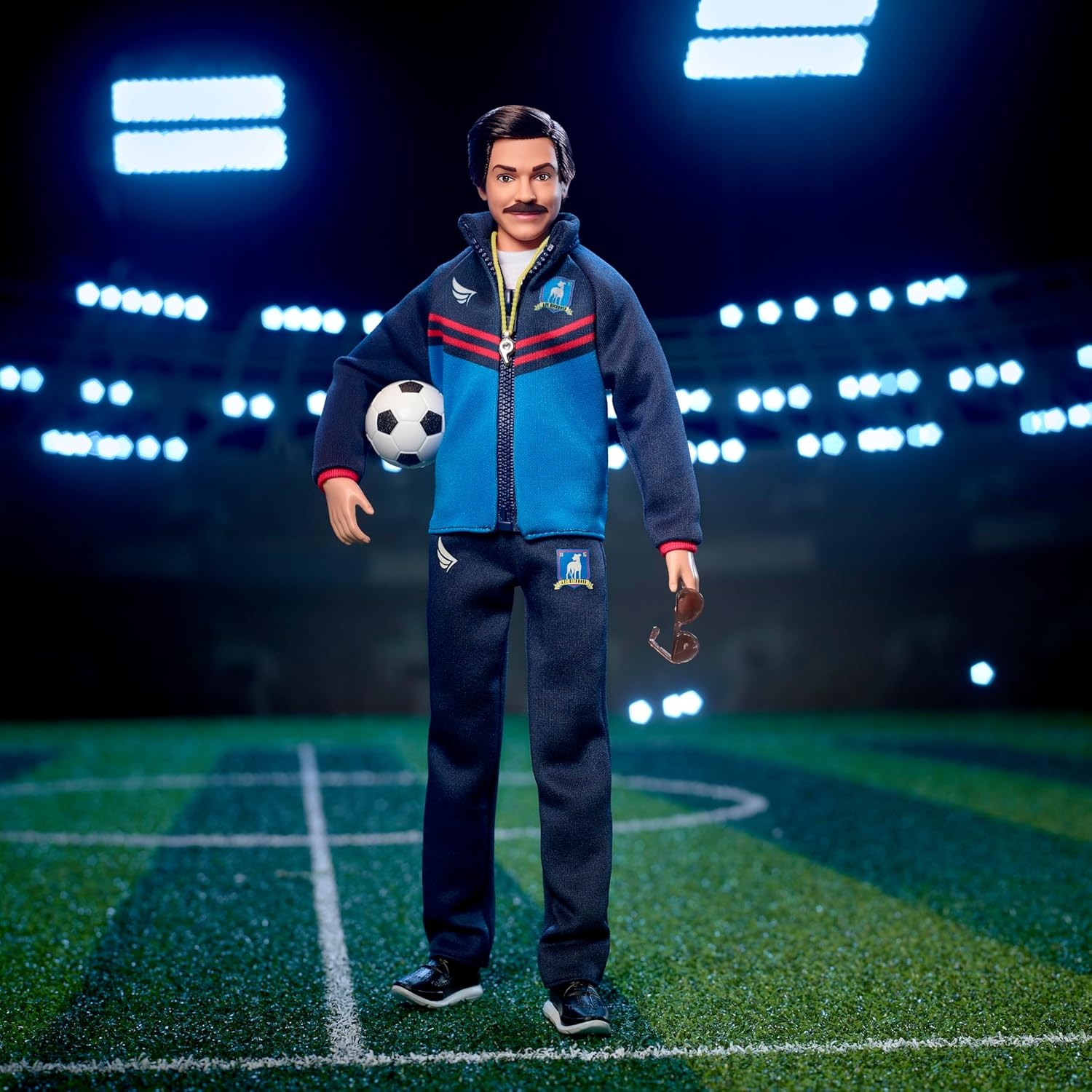 imageBarbie Signature Fashion Doll Ted Lasso Wearing Blue Tracksuit with AFC Richmond Logo Collectible in Displayable PackagingMulticoloured
