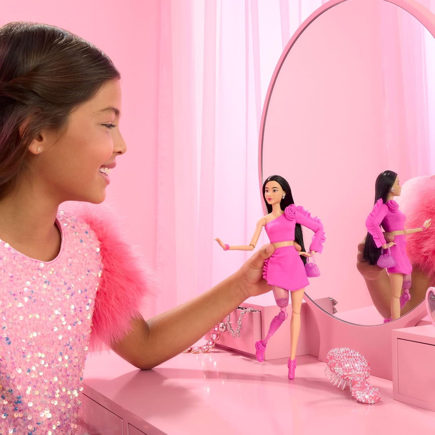 imageBarbie Deluxe Style Doll 2 in Barbiecore Outfit Black Hair and Glittery Prosthetic Leg Pink Top and Skirt Set with Rosette Detail and AccessoriesMulticolor